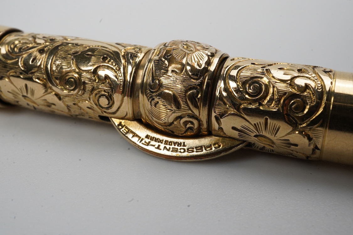 A Conklin ring top hand engraved crescent filler fountain pen with 14ct. gold Conklin nib